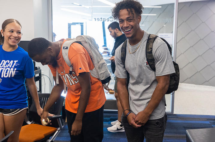 students smiling and laughing in front of camera