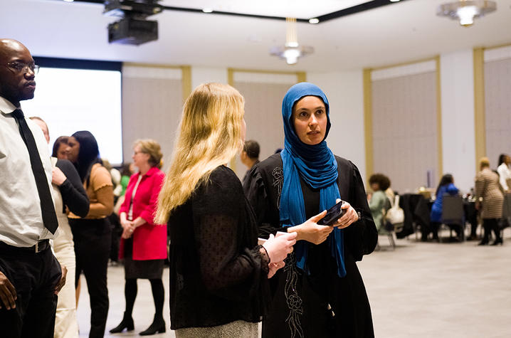 two women in conversation in a ballroom