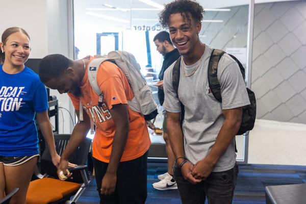 students smiling and laughing in front of camera