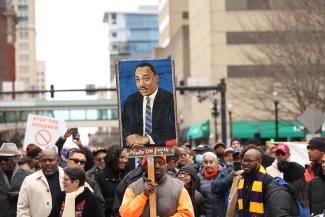 Poster of painting of MLK raised during the march in downtown Lexington